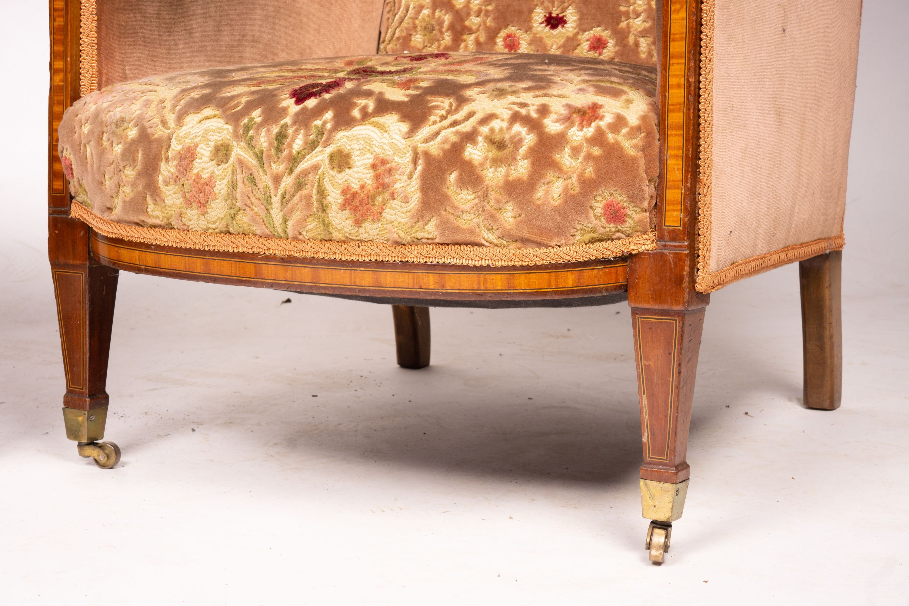 A pair of Edwardian satinwood banded mahogany wing armchairs, width 56cm, depth 75cm, height 110cm